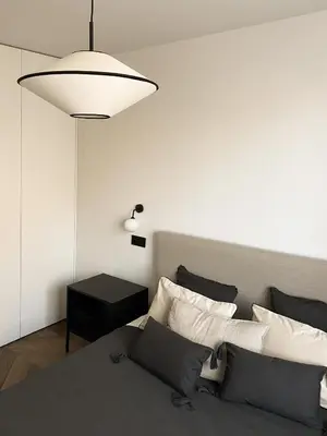 a bedroom with a bed with a white wall at Apartament BonHaus Grzegórzecka in Kraków