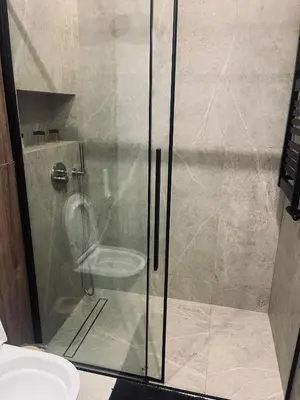 a glass shower in a bathroom with a toilet at Apartament BonHaus Grzegórzecka in Kraków