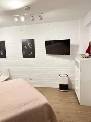 a bedroom with a bed and a tv on a wall at Apartment Family Dreams Old Town in Kraków