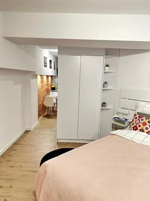 a bedroom with a bed and a room with a desk at Apartment Family Dreams Old Town in Kraków