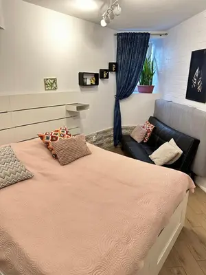 a bedroom with a large bed and a couch at Apartment Family Dreams Old Town in Kraków