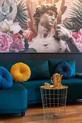 a living room with a blue couch and a table at Vintage Studencka 1 Apartment in Kraków
