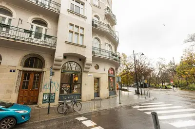 a blue car parked in front of a building at Vintage Studencka 1 Apartment in Kraków