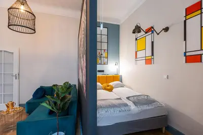 a bedroom with a bed and some stained glass windows at Vintage Studencka 1 Apartment in Kraków
