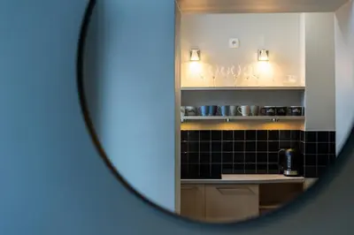 a view of a kitchen through a mirror at Vintage Studencka 1 Apartment in Kraków