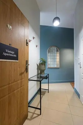 a door in a hallway with a table next to it at Vintage Studencka 1 Apartment in Kraków