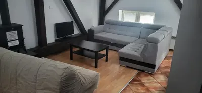a living room with a couch and a table at 777 Apartments 2 in Kraków