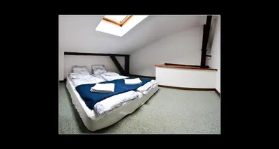 a bedroom with a bed with blue sheets and towels at 777 Apartments 2 in Kraków