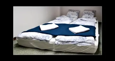 a bed with towels on it in a bedroom at 777 Apartments 2 in Kraków