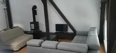 a living room with a couch and a tv at 777 Apartments 2 in Kraków