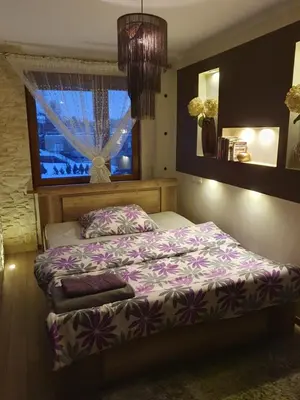 a bedroom with a bed and a window at Apartament Daria in Jaworzno