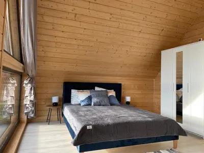 a bedroom with a bed in a wooden cabin at Górne Chaty Zawoja in Zawoja