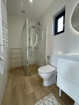 a white bathroom with a toilet and a shower at Górne Chaty Zawoja in Zawoja