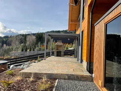 a building with a stone walkway outside of it at Górne Chaty Zawoja in Zawoja