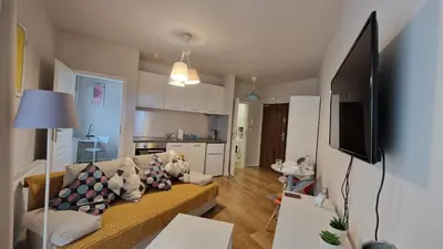 a living room with a couch and a television in it at Apartament Wieliczka in Wieliczka