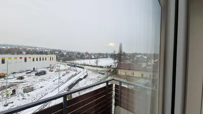 a view of a snowy city from a balcony at Apartament Wieliczka in Wieliczka