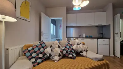 a living room with a couch with pillows on it at Apartament Wieliczka in Wieliczka