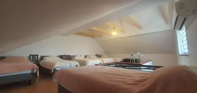a room with three beds in a attic at Jaga Family Apartment air conditioner and free parking in Kraków