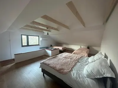 a bedroom with two beds and a desk in a attic at Jaga Family Apartment air conditioner and free parking in Kraków