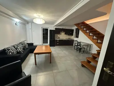 a living room with a couch and a table at Jaga Family Apartment air conditioner and free parking in Kraków