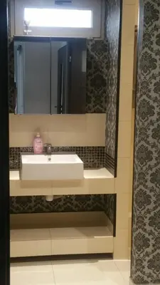 a bathroom with a sink and a mirror at Jaga Family Apartment air conditioner and free parking in Kraków