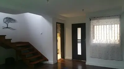 a living room with a staircase and a window at Jaga Family Apartment air conditioner and free parking in Kraków