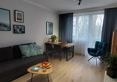 a living room with a couch and a table at MR HOME APARTMENTS - Nullo in Kraków