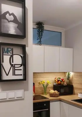 a kitchen with white cabinets and a window at MR HOME APARTMENTS - Nullo in Kraków