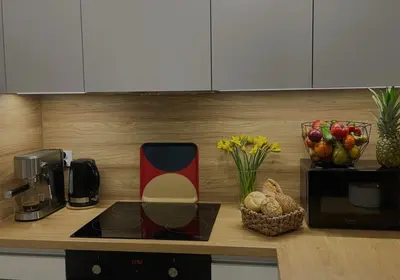 a kitchen counter with a coffee maker and a bowl of fruit at MR HOME APARTMENTS - Nullo in Kraków