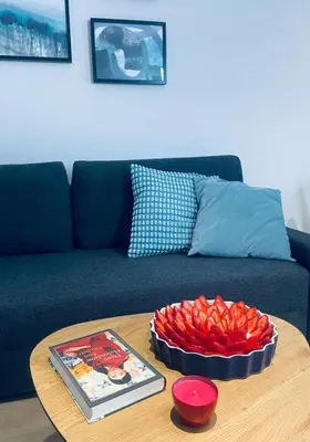 a table with a bowl of red peppers on a couch at MR HOME APARTMENTS - Nullo in Kraków