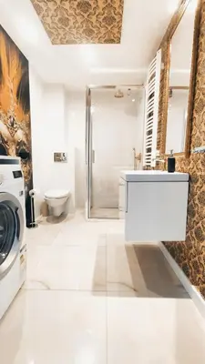 a bathroom with a sink and a washing machine at Augustiańska 24 by Homeprime in Kraków