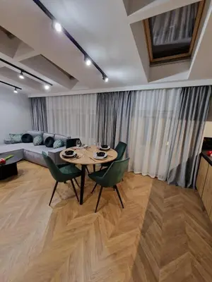 a living room with a table and chairs and a couch at Apartamenty Sebastiana in Kraków