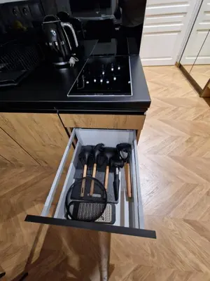 a drawer in a kitchen island with a stove at Apartamenty Sebastiana in Kraków