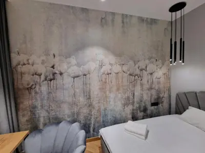 a room with a painting of birds on the wall at Apartamenty Sebastiana in Kraków