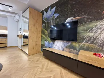 a living room with a large tv on a wall at Apartamenty Sebastiana in Kraków