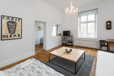 a living room with a table and a couch at Krakow 25 Old Town Apartament in Kraków