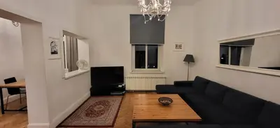 a living room with a couch and a table at Krakow 25 Old Town Apartament in Kraków