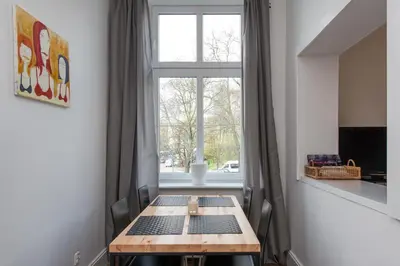 a room with a table in front of a window at Krakow 25 Old Town Apartament in Kraków