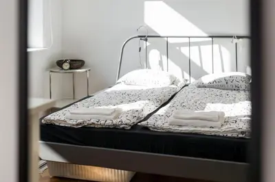 a bed with white sheets and pillows on it at Krakow 25 Old Town Apartament in Kraków