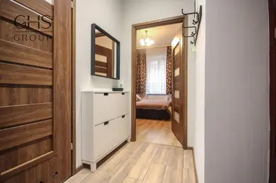 a hallway with a dresser and a mirror in a room at Piękny apartament w centrum Krakowskiego Kazimierza in Kraków