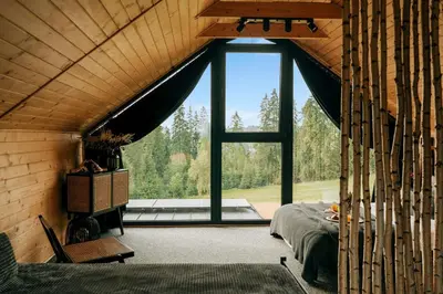 a room with a bed and a large window at ArtHouse Podhale in Klikuszowa