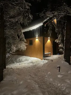 a house with a snow covered yard at night at ArtHouse Podhale in Klikuszowa