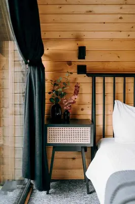 a table with a plant on it next to a bed at ArtHouse Podhale in Klikuszowa