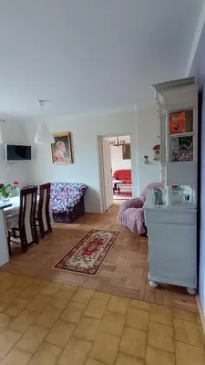 a living room with a kitchen and a dining room at Dom na szlaku Krakowskim in Łączany