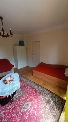 a living room with a red couch and a table at Dom na szlaku Krakowskim in Łączany
