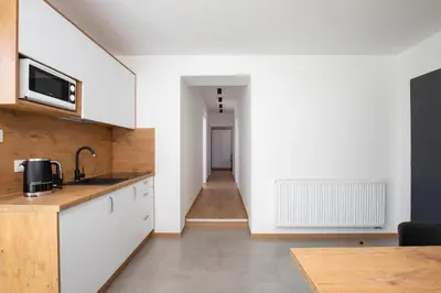 a kitchen with a sink and a microwave at Gorczański Zakątek Jacuzzi & Sauna in Niedźwiedź