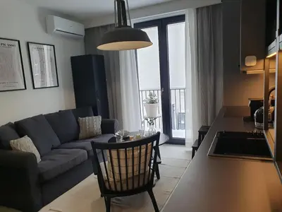 a living room with a couch and a table at Fly_to_Cracow_18 in Kraków