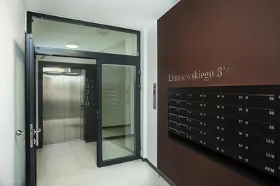 a hallway with a glass door and a door to a room at Fly_to_Cracow_18 in Kraków
