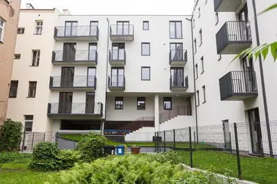 an apartment building with balconies and a yard at Fly_to_Cracow_18 in Kraków