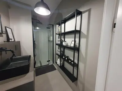 a bathroom with a glass shower and a sink at Fly_to_Cracow_18 in Kraków